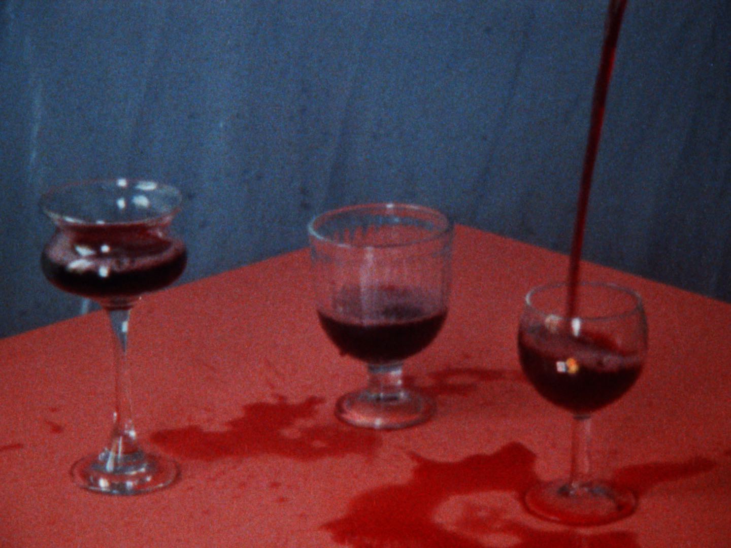 three glasses with wine spilled